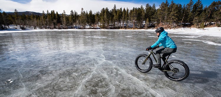 Un cycliste de fat bike qui se promène sur un lac glacé